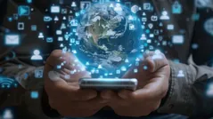 Hands holding a smartphone with a glowing globe and social media icons representing social media marketing