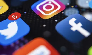 Social media app icons including Instagram, Facebook and Twitter on a smartphone screen