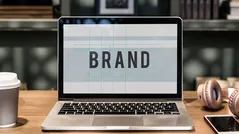 Laptop screen displaying the word BRAND representing branding services